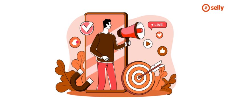 Grafika kreskówkowa mężczyzny wychodzącego z megafonem z telefonu, obok serduszka i lajki. Temat wpis: interaktywne treści w e-commerce.